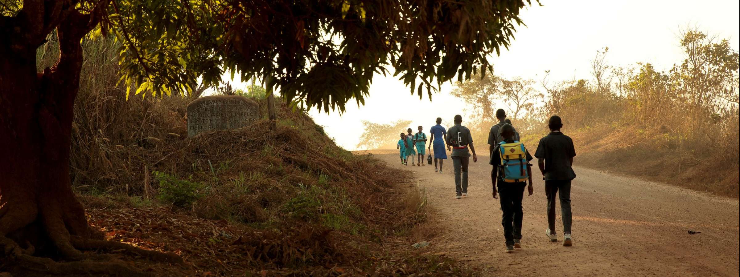 Cameroon. Children walk to school in the morning in the town of Yoko.