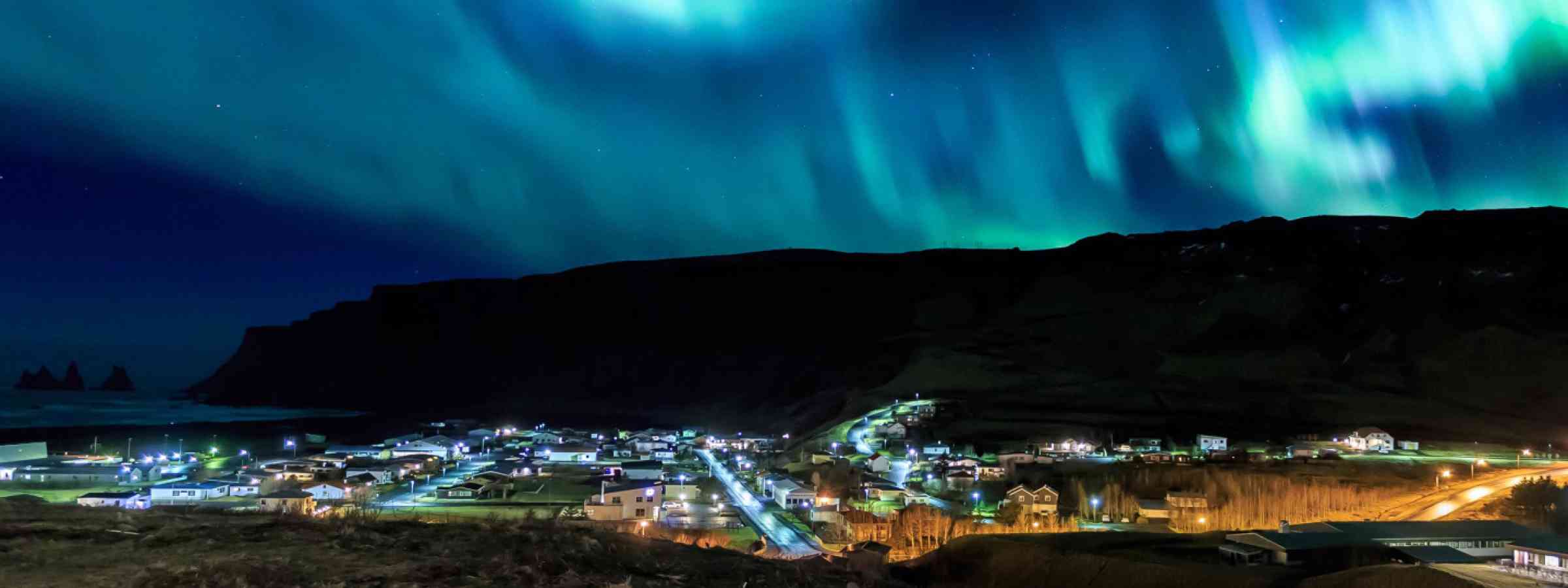 he Northern Light aurora over Vik city in Iceland
