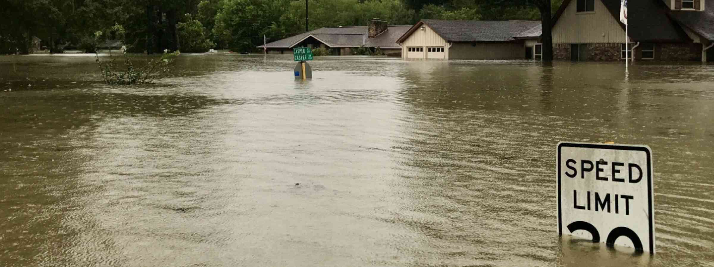 Speed limit sign almost completely submerged by a flood caused by Hurricane Harvey in 2017.
