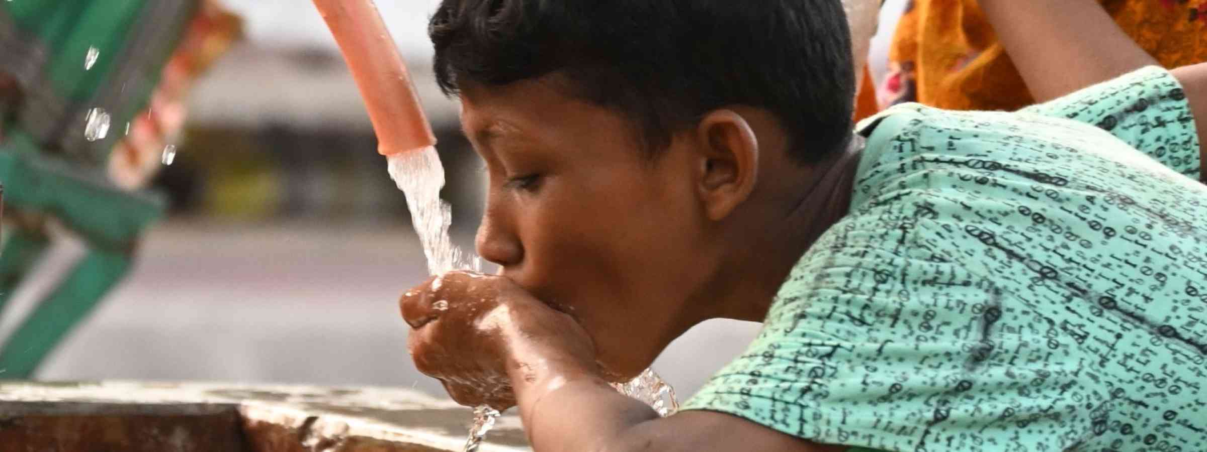 Boy drinking water in Bangladesh